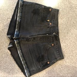 Black distressed jean short with bead trim
